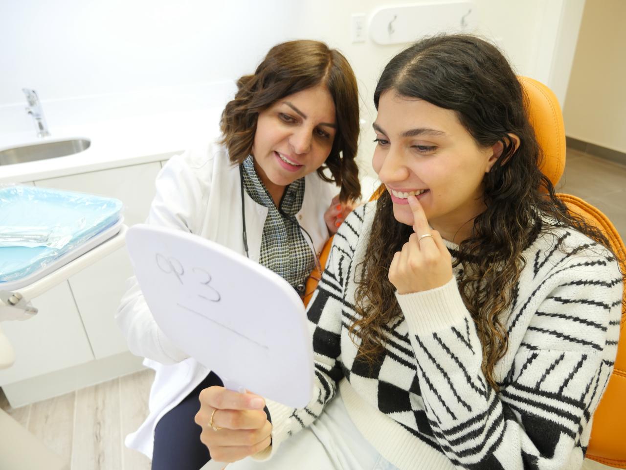 Dr. Parsi with a patient at Fort Dental Clinic, Toronto